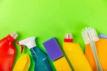 Cleaning service concept.Home cleaning product on a green background. Bucket with household chemicals. cleaning supplies for home or office space.Early spring regular cleaning. Copy space