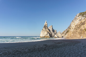 Praia da Ursa beach with rock formation on a sunny day, in Sintra, Lisbon, Portugal