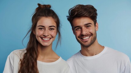 Cheerful poses from a stylish young couple against a bright studio backdrop.