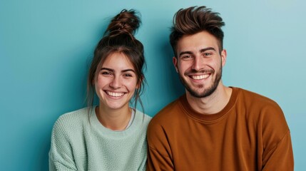 Fototapeta premium Happy couple with stylish hair posing joyfully in a studio.