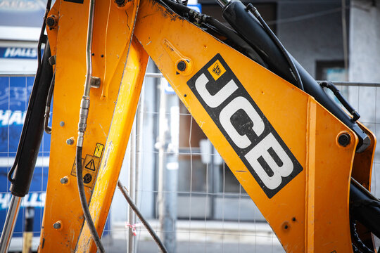 BELGRADE, SERBIA - JULY 22, 2022: JCB logo on one of their machinery engine, an excavator, in a construction site of Belgrade. JCB, or JC Bamford Excavators, is an industrial vehicle manufacturer.