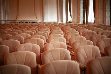 Selective blur on rows empty chairs in a conference room used for business meetings.