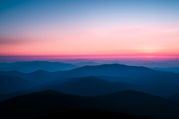 Obraz premium Sunset Radiance Over Mountainous Silhouettes