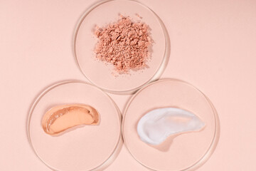 Different smears and drops of cream on a beige background. Skin care cosmetics cream, scrub,...