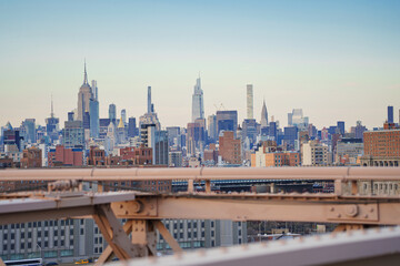 Panorama view of New York city from Brooklyn bridge at sunset.