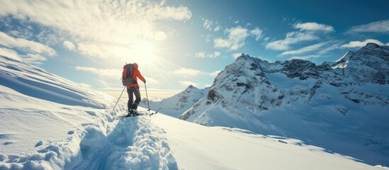 Mountaineer backcountry ski walking ski alpinist in the mountains Ski touring in alpine landscape with snowy trees Adventure winter sport. Copy space image. Place for adding text - obrazy, fototapety, plakaty