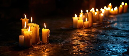 Religious and devoutness scene candles burning in the dark. Copy space image. Place for adding text - obrazy, fototapety, plakaty