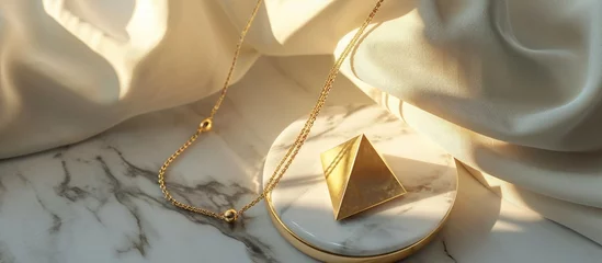 Poster Modern minimalist geometric golden necklace on white marble plate Necklace in the form of three triangles Women accessories. Copy space image. Place for adding text © Ilgun