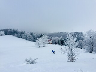 Skier going down the slope in the mountains