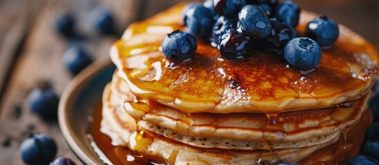 Stack of pancakes with blueberries and maple syrup Closeup view Tasty american pancakes. Copy space image. Place for adding text