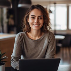 Photo of joyful nice woman using laptop. Beautiful Businesswoman typing on laptop.