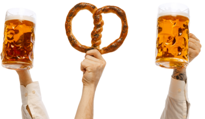 Hands holding hot delicious sausage on fork, pretzel and two mugs of cold lager light mugs of beer against transparent background. Concept of Oktoberfest, traditions, Bavarian culture, alcohol drinks.