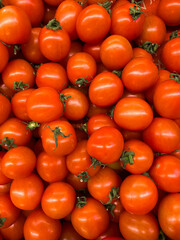 Set of small tomatoes top view. Delivery of vegetables, sale of vegetables in markets and supermarkets. Red vegetable background