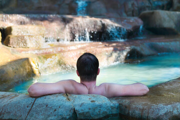 Men relaxing in pool at termal resort