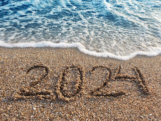 New year 2023 handwritten in the sand surface