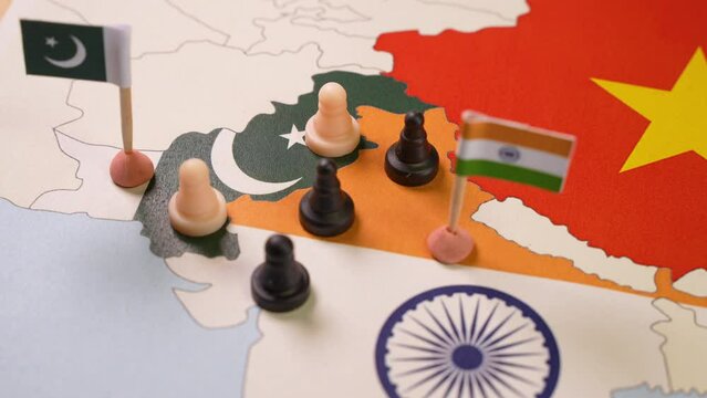 Chess pieces over a map of Idnia and China. indo-pakistani Border Dispute . Selective focus