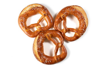 Three Bavarian Pretzel with Salt on White Background Top View