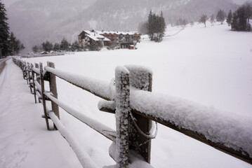 Winter landscape, wooden fence covered with snow