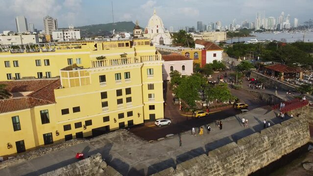 Cartagena, Colombia: Aerial drone footage of tourists who visit the famous fortified colonial old town of Cartagena in Colombia with the San Pedro Claver church. 