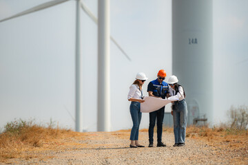 Team of engineers and architects working on wind turbines in a wind farm