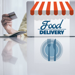 Man behind computer purchase food online. Credit card in hand. Home delivery, fast food concept.
