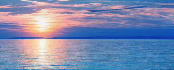 Naklejka na ściany i meble Seascape early in the morning. Sunrise over the sea. Natural landscape. Horizontal banner