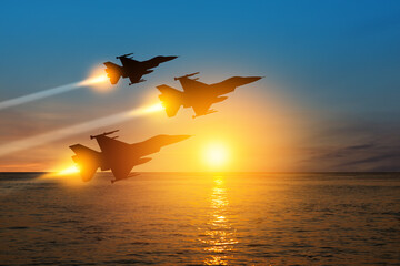 Air Force Day. Aircraft silhouettes on background of sunset on the sea. - obrazy, fototapety, plakaty