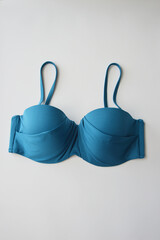 Women's swimsuit. Beautiful blue turquoise bra on a white background. Beachwear.
