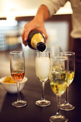 Champagne flutes are being filled on a digustation