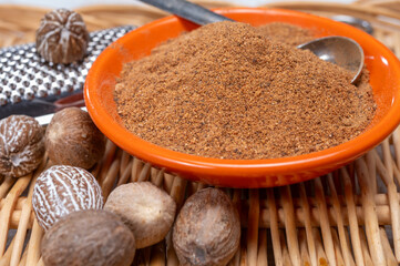 Tasty winter spice whole dried and ground powder nutmeg, used as an ingredient in many dishes, eggnog, potato, mulled wine
