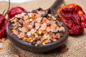 Pink himalayan salt chrystals with dried seeds of red hot chili peppers and herbs, cooking with exotic salt