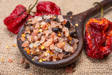 Pink himalayan salt chrystals with dried seeds of red hot chili peppers and herbs, cooking with exotic salt