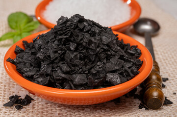 Black and white sea salt close up, Cyprus Black Salt shiny black pyramid-shaped crystals