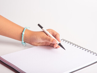 School supplies, teenager's hand drawing with markers, white background, selective focus.