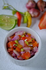 Sambal Dabu-dabu is a typical chili sauce from North Sulawesi or the city of Manado made from fresh tomatoes, cayenne pepper, sliced shallots, lime juice, salt, and oil. Indonesian food.