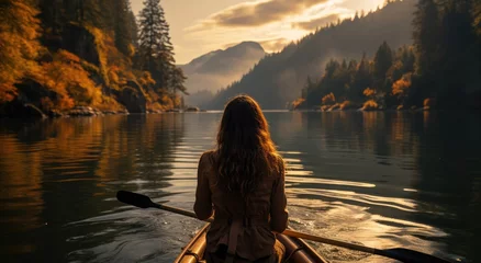Fotobehang Mistige ochtendstond As the misty fog settled over the tranquil lake, a lone woman paddled her canoe towards the fiery sunset, surrounded by the serene beauty of nature's embrace