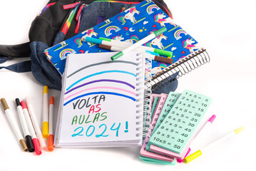 School supplies, school supplies in backpack with notebook written back to school 2024, white background, selective focus.