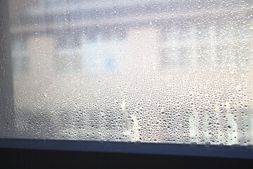Drops of condensation on the metal-plastic window. Fragment of a plastic window with water...