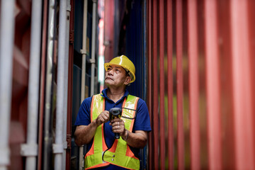 Foreman or worker work at Container cargo site check up goods in container. Foreman or worker checking on shipping containers. Logistics and shipping.