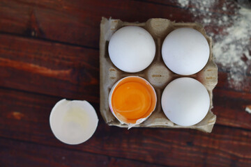  concept cooking four eggs one of them is broken flat lay