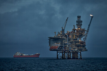 Crude oil production in the sea with jackup drilling rig and floating production storage tanker...