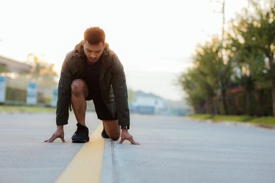 Portrait of a young Asian man in sports clothes jogging in the morning. man running at sunrise health care