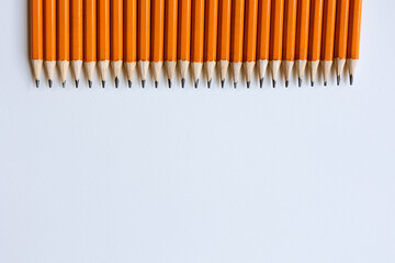 Yellow pencils lie on a white background.