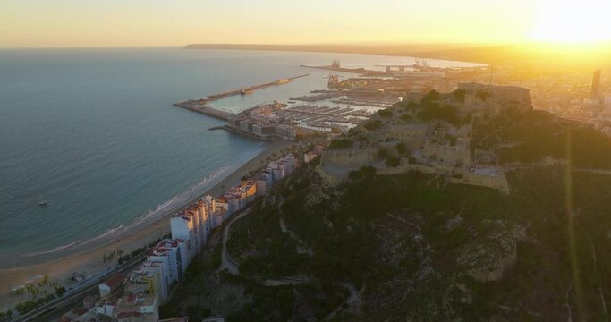 Sunset over the city center and marina of Alicante city, medieval fortess of Santa Barbara. Spain, Costa blanca