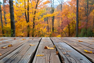 Naklejka na ściany i meble Wooden deck with scattered leaves overlooking vibrant autumn forest