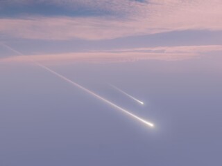 Meteors in the daytime sky at sunset. Fireballs light up the sky. Beautiful bright meteorites.