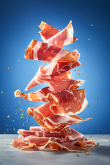 Slices of cured ham jamon Serrano Proscuitto, levitation floatinf food, blue background.