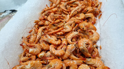 Chilled boiled shrimp in a supermarket or grocery store, close-up. Seafood