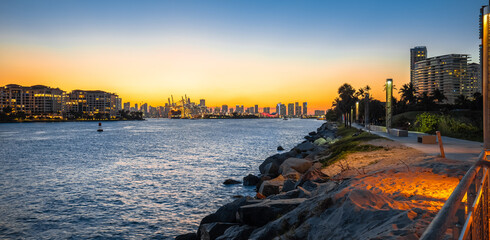Miami beach walkway and Miami skyline sunset panoramic view