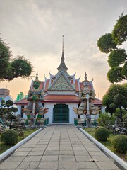 Buildings in Wat Arun  with two giants standing in front